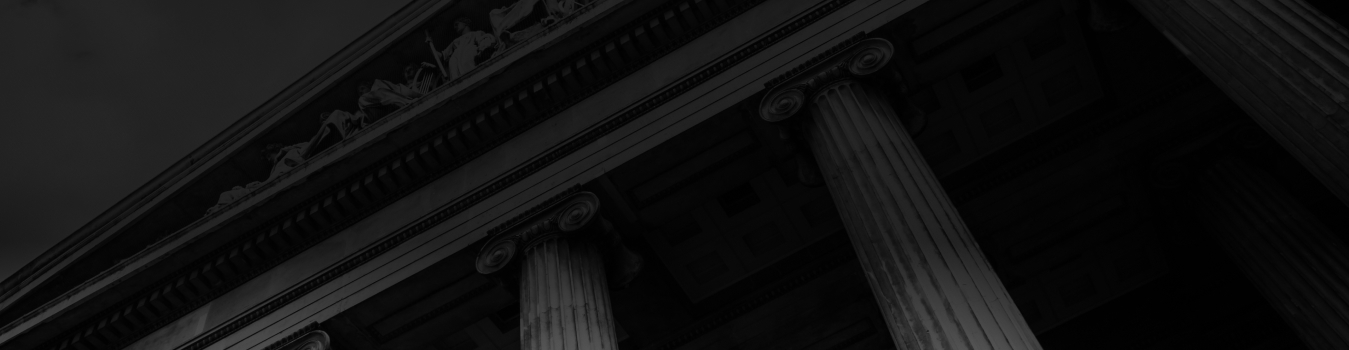 Faded Background image of a courthouse with white pillars and intricate details.